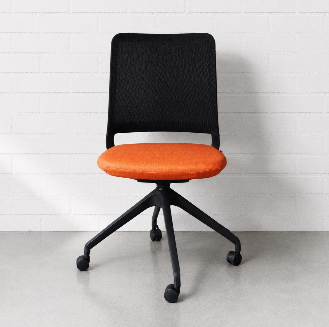 Studio Modern Yutu Low Back Chair with Black Frame and 4 Star Wheelbase with Koi Orange Seat