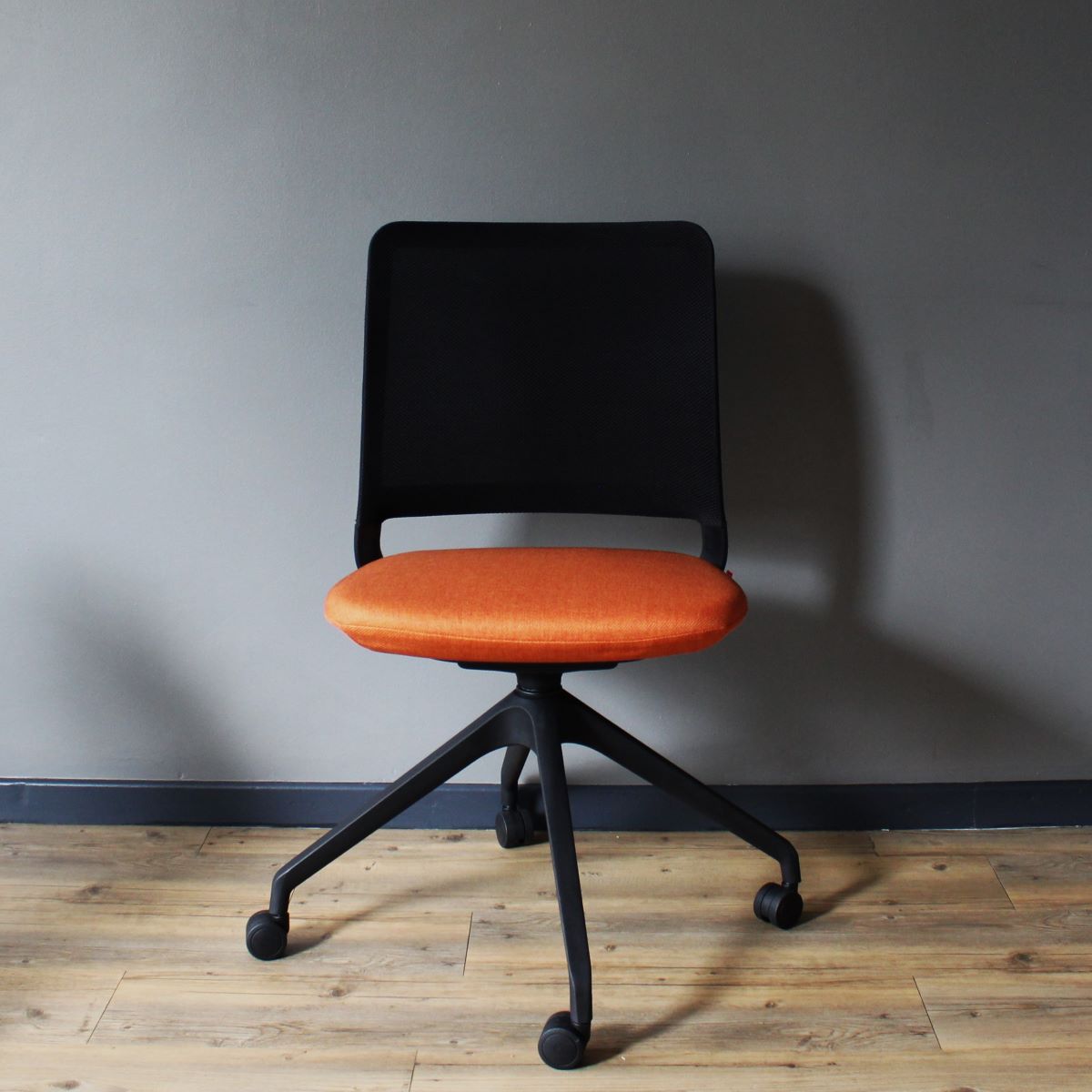 Studio Modern Yutu Low Back Chair with Black Frame and 4 Star Wheelbase with Koi Orange Seat